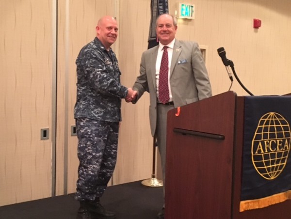 During the chapter's June luncheon, Chapter President Palmer Sims (r) thanks guest speaker Capt. Matthew R. Lear, USN, commanding officer for the Naval Computer and Telecommunications Area Master Station Atlantic.  